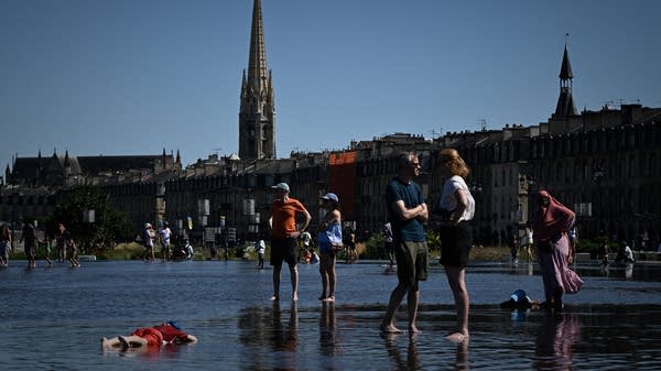 Above, people cool off in a reflecting pool on the banks of the Garonne River in Bordeaux on July 6.