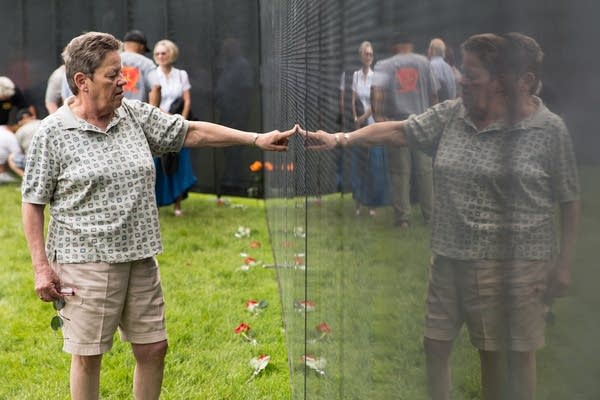 Mary Clare Huberty touches her brother's name