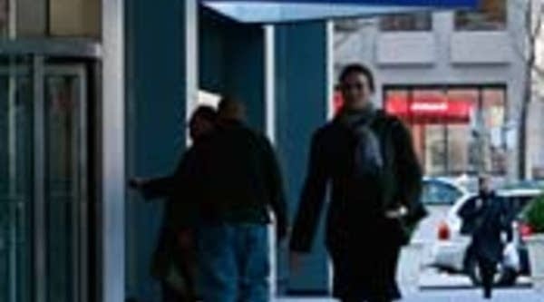 People walk outside Citigroup headquarters beneath a Citibank sign in New York City.