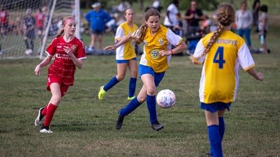 A child kicks a soccer ball