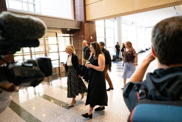 People walk through a courthouse lobby