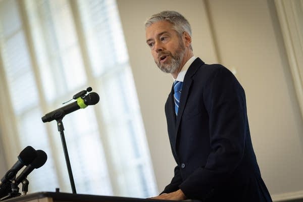 A man speaks at a podium