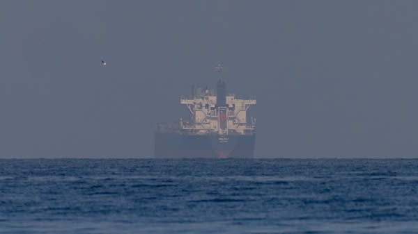 Above, a shipping vessel near the Strait of Hormuz on March 22. Rates to insure ships transiting the Strait of Hormuz have surged since the outbreak of war in the region.