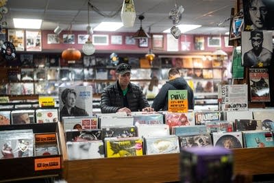 People browse records in a record store