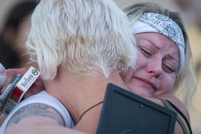 A woman hugging another person. 