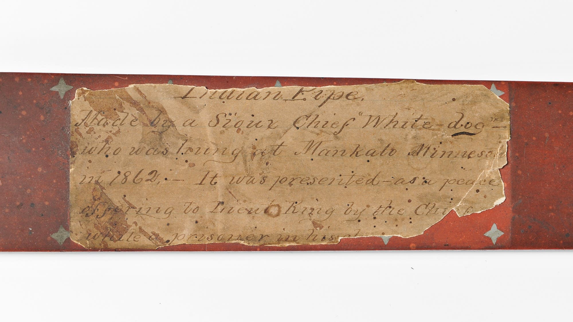 An old paper label reads 'Indian pipe, Made by a Sioux Chief White Dog.'