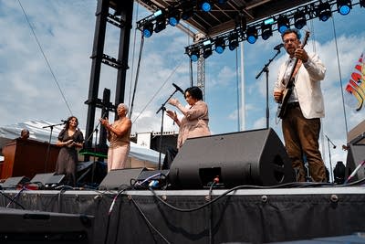 The union and phil cook performing on an outdoor stage