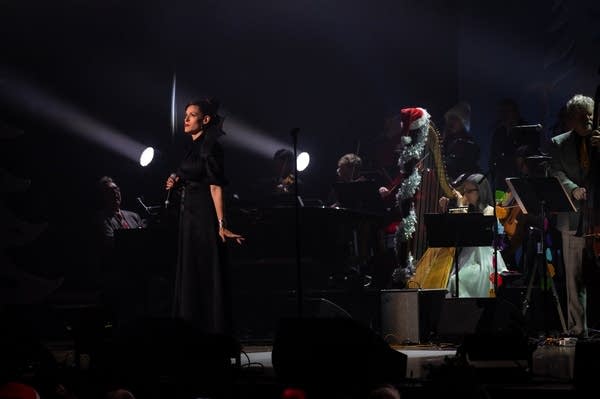 a singer with large backing band on stage