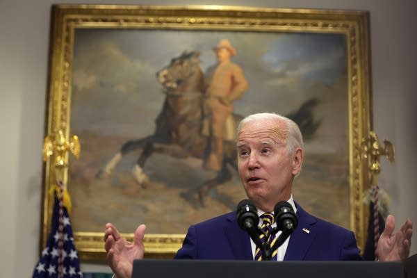 A person stands in front of a podium.