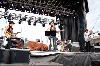 A band performing on an outdoor stage