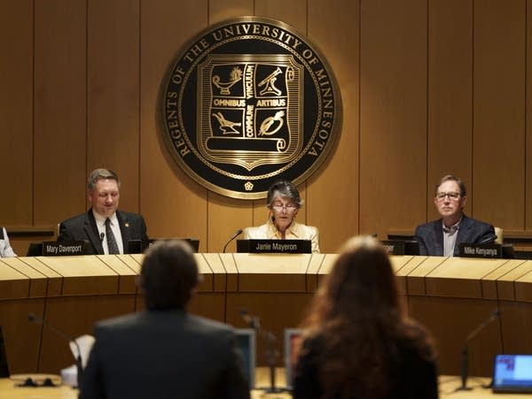 Speakers at a university board of regents meeting