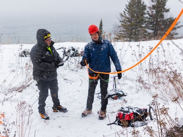 Two people prepare to climb