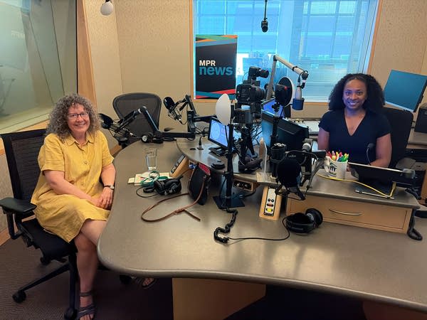 two women smiling in a broadcast studio