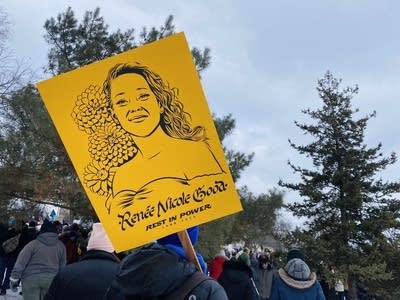 a person holds a sign