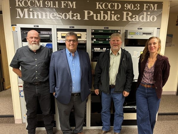 Four people stand in the Moorhead bureau of MPR News.