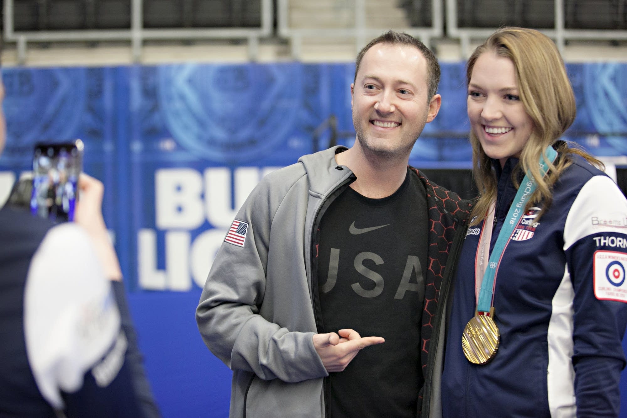 Olympic curler Tyler George poses for a photo with curler Lexi Lanigan.