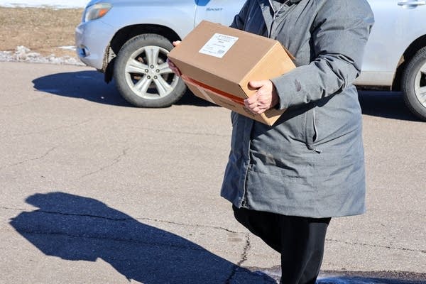 woman carrying a box