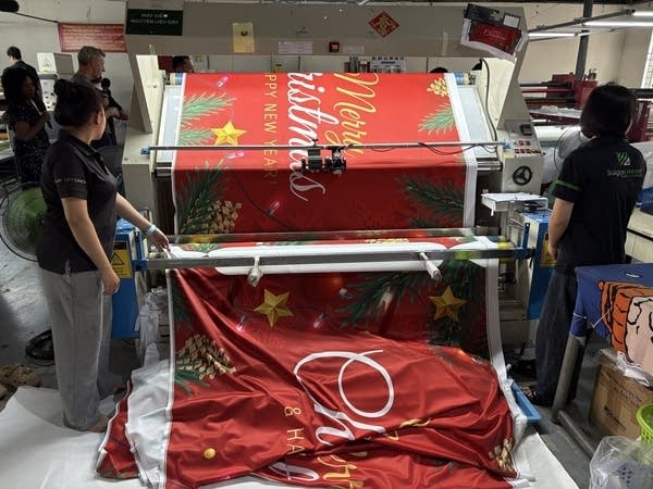 One of Garage Celebrations’ door covers coming off an industrial textile printer at Saigon Printer’s factory in Vietnam.