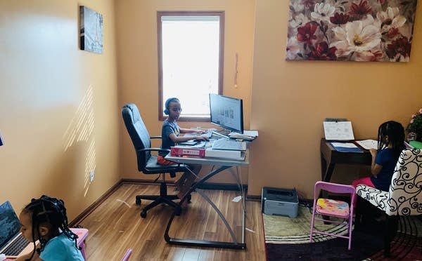 Children sitting at desks doing schoolwork.