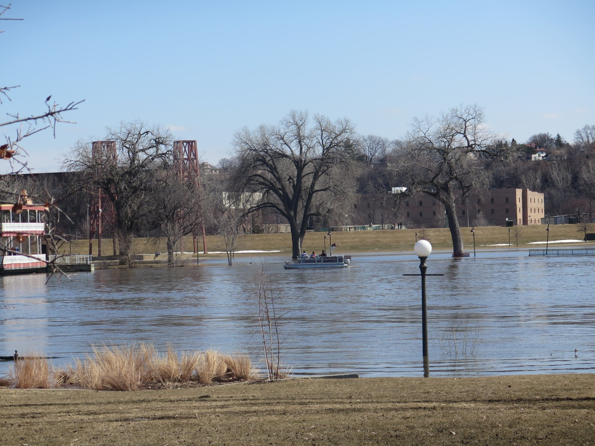 A pontoon boats down the Mississippi River in St. Paul.