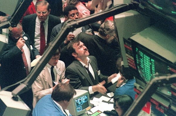 NEW YORK, NY - OCTOBER 19:  A trader (c) on the New York Stock Exchange looks at stock rates 19 October 1987  as stocks were devastated during one of the most frantic days in the exchange's history.  The Dow Jones index plummeted over 200 points in record trading.