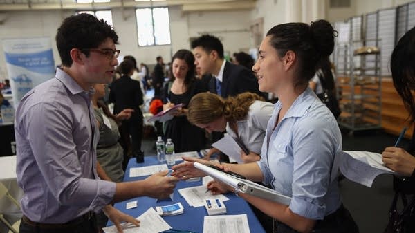 Unemployment in your 20s can have long-term consequences for your earning potential, says Conor Sen, columnist at Bloomberg. Above, students connect with potential employers at a career fair.