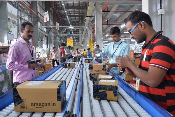 Employees of Amazon India scan packages at Amazon's newly launched fulfilment center on the outskirts of Bangalore.  (Photo: MANJUNATH KIRAN/AFP/Getty Images)