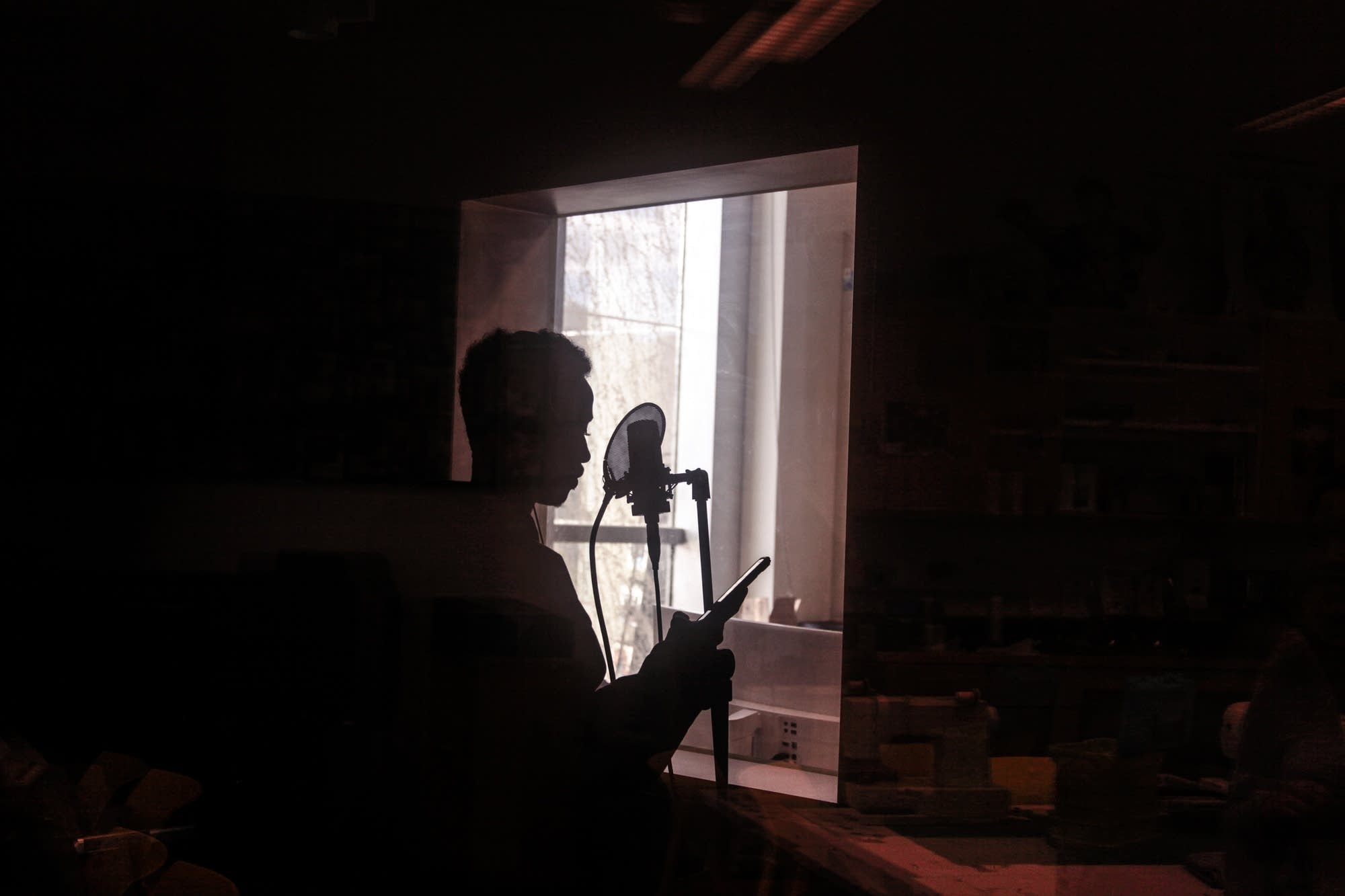 A young man raps in the studio of the Teen Tech Center.