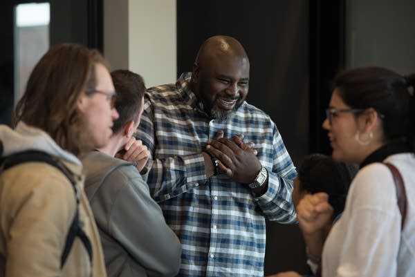 Edrin Williams, pastor of equipping and formation, talks with people.