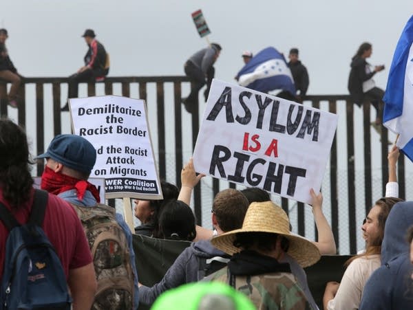 Pro-migrant demonstrators rally at the west end of the U.S.-Mexico border.