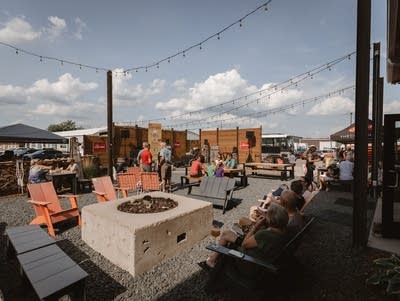 A group of people sit on an outdoor patio.