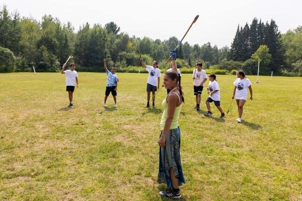 woman raising stick