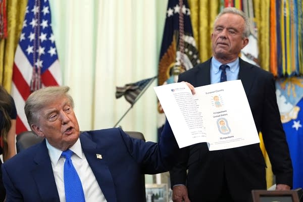 A person holds up a piece of paper