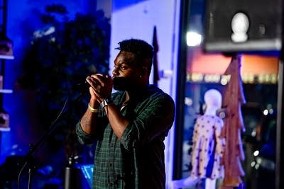 A musician sings onstage in a music venue