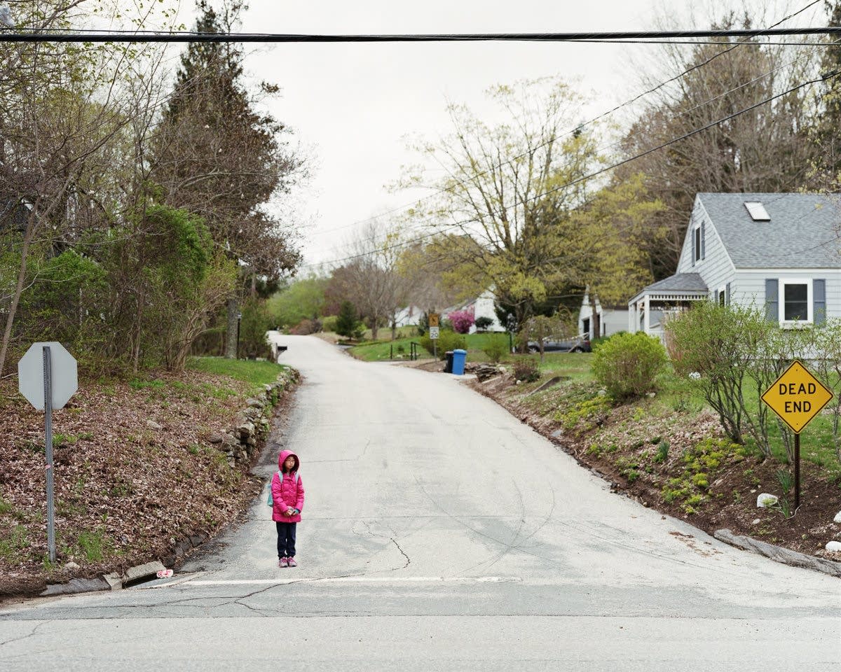 Children wait for their morning bus to school.