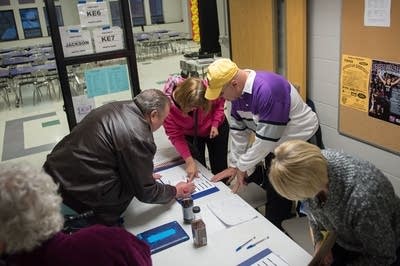 Caucus workers check in voters.