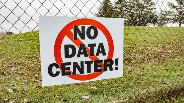 A sign voicing opposition to the Farmington data center project is seen on a golf course fence in November 2024.
