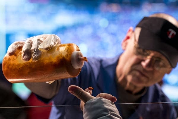 A worker gives a sauce sample. 