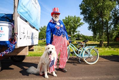 A man in American themed attire with his dog