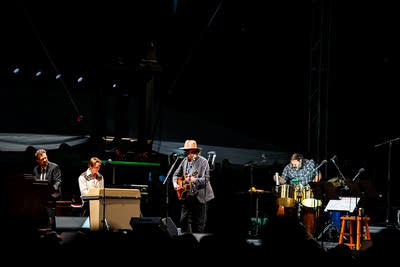 A band performing on an outdoor stage