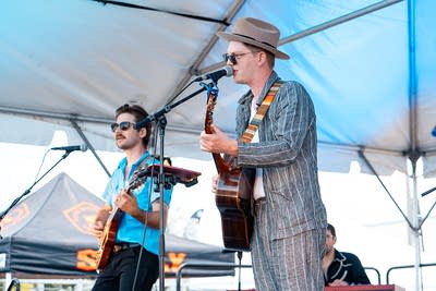 A band performing on an outdoor stage