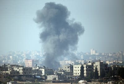 A plume of smoke rises above Gaza City