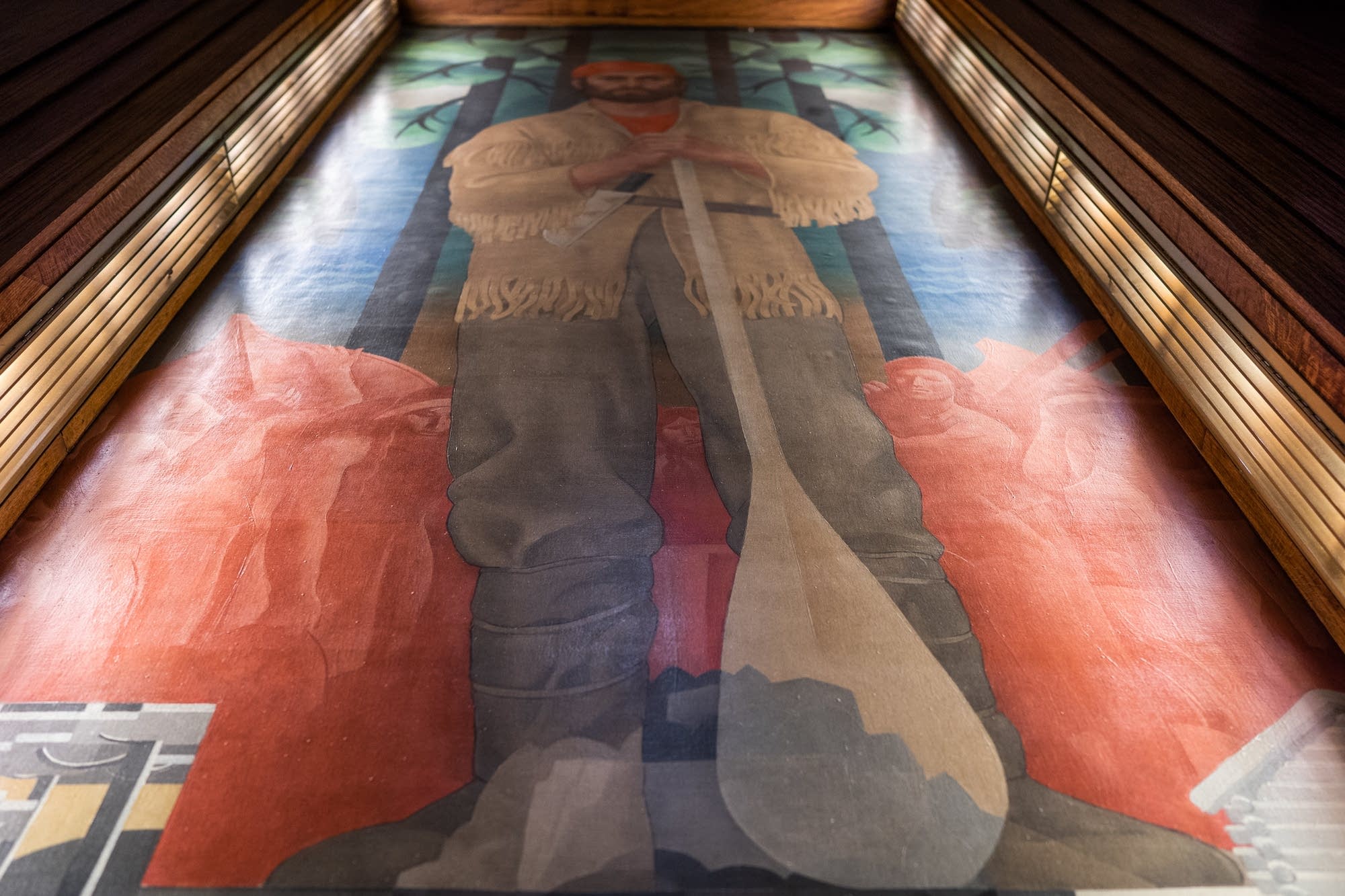 A white man who appears to be a fur trader in a mural.