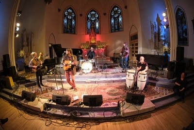 Six musicians performing onstage