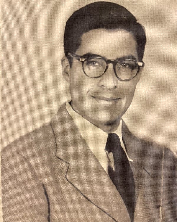 A black and white portrait of a man in a suit and tie 