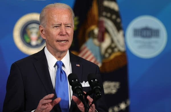 A man speaks in front of a microphone. 