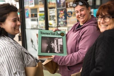 Three people smiling with their records