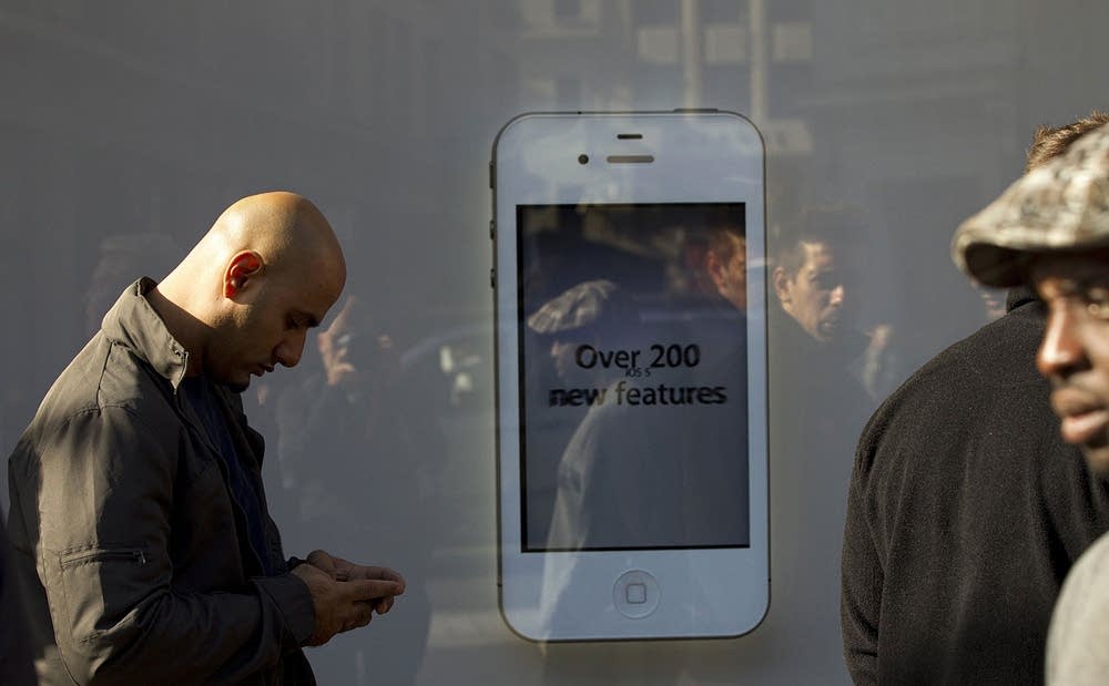 A man sends a message on his iPhone