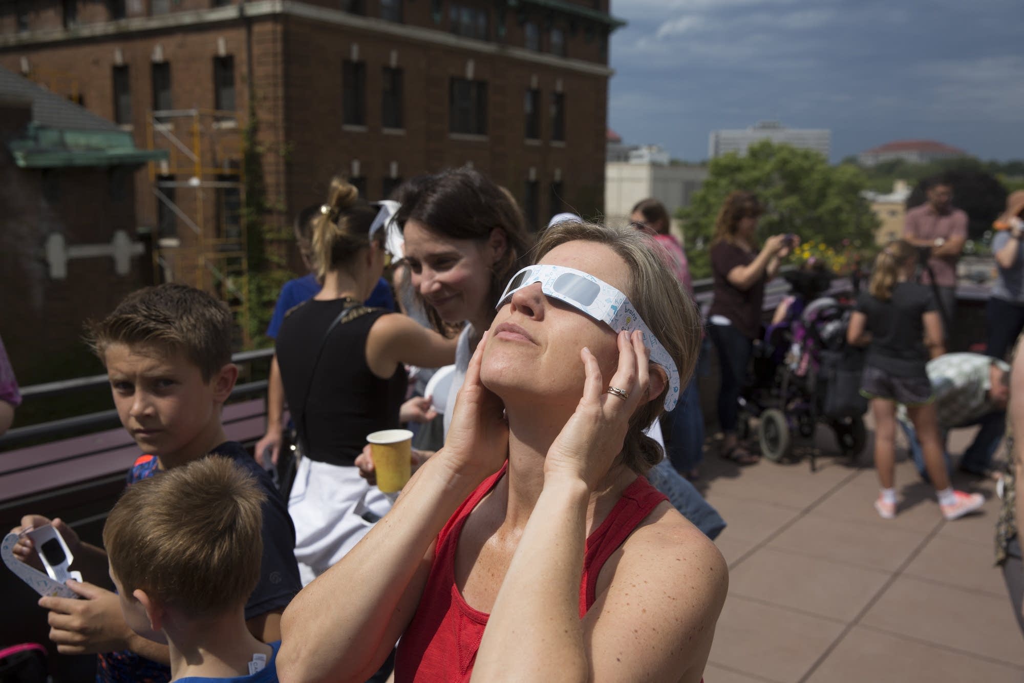 A woman looks up at the eclipse.