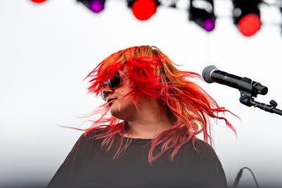 Gash performing on an outdoor stage.